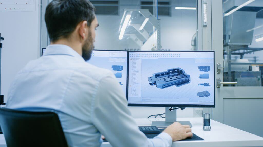 Engineer/ Technician Working on a Personal Computer with Two Dis