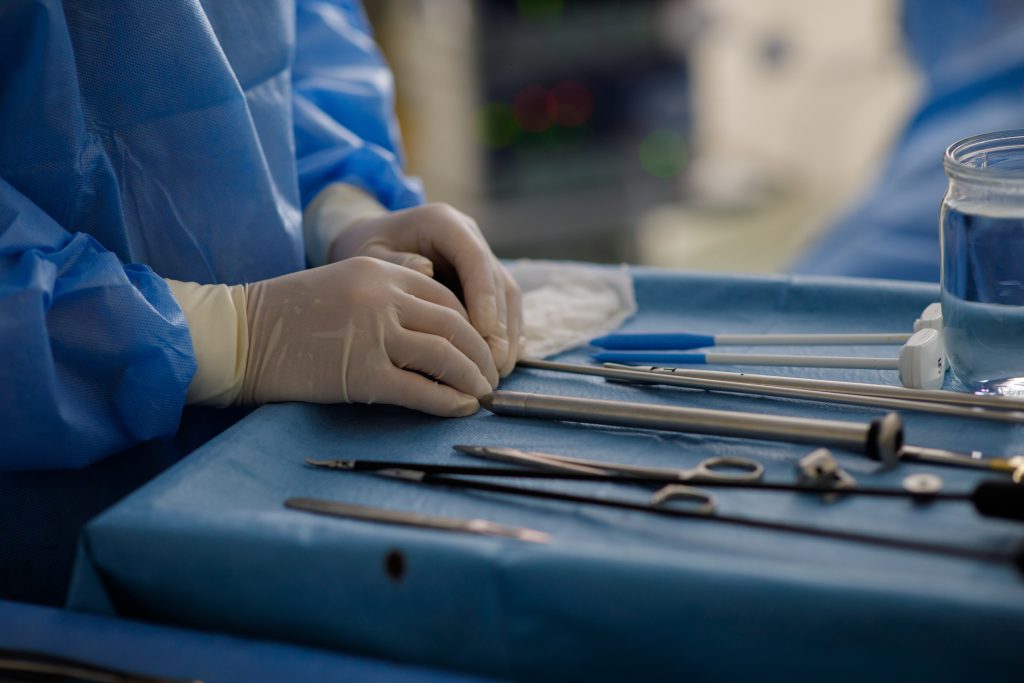 sterile instruments for surgery on the tray and hands